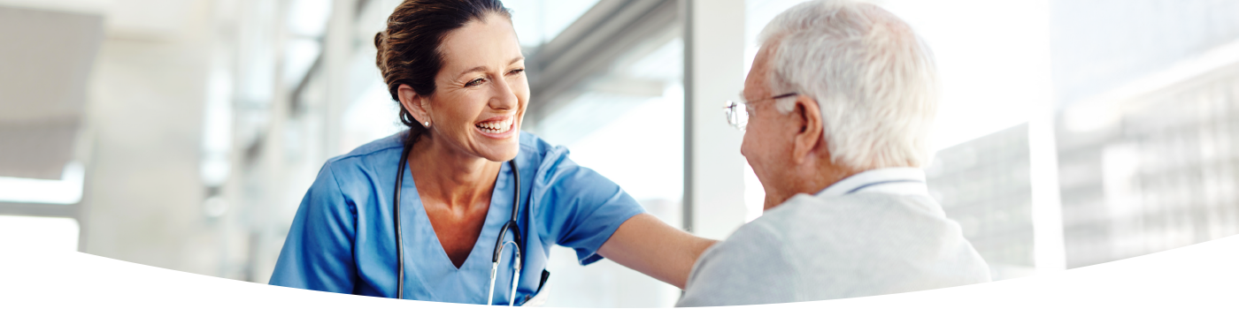 Female nurse with male patient in wheelchair